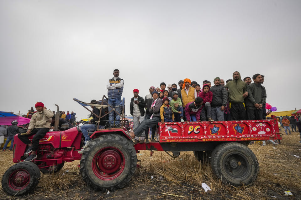 Villagers on a tractor watch a buffalo fight held as part of the Magh Bihu harvest festival at Ahotguri village, east of Guwahati, in the northeastern state of Assam, India, Jan. 16, 2024. Traditional bird and buffalo fights resumed in India’s remote northeast after the supreme court ended a nine-year ban, despite opposition from wildlife activists. (AP Photo/Anupam Nath)