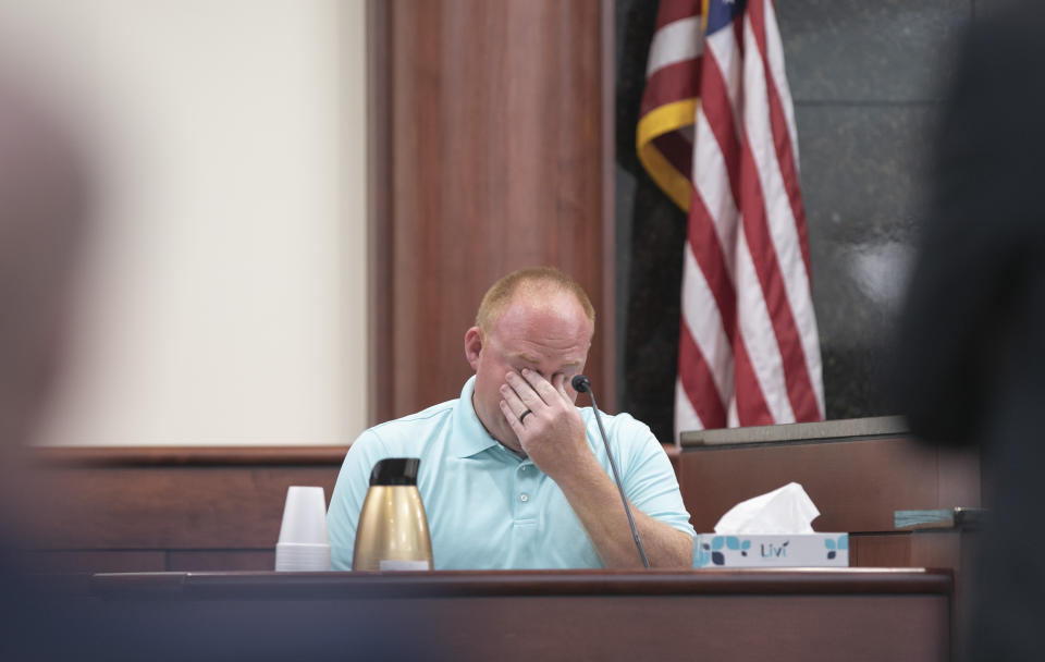 Jonathan Stone, Nahtahn Jones's kindergarten teacher, wipes his eyes while talking about Nahtahn Jones during the sentencing phase of the trial of Tim Jones in Lexington, S.C. on Friday, June 7, 2019. Jones, was found guilty of killing his 5 young children in 2014. (Tracy Glantz/The State via AP, Pool)