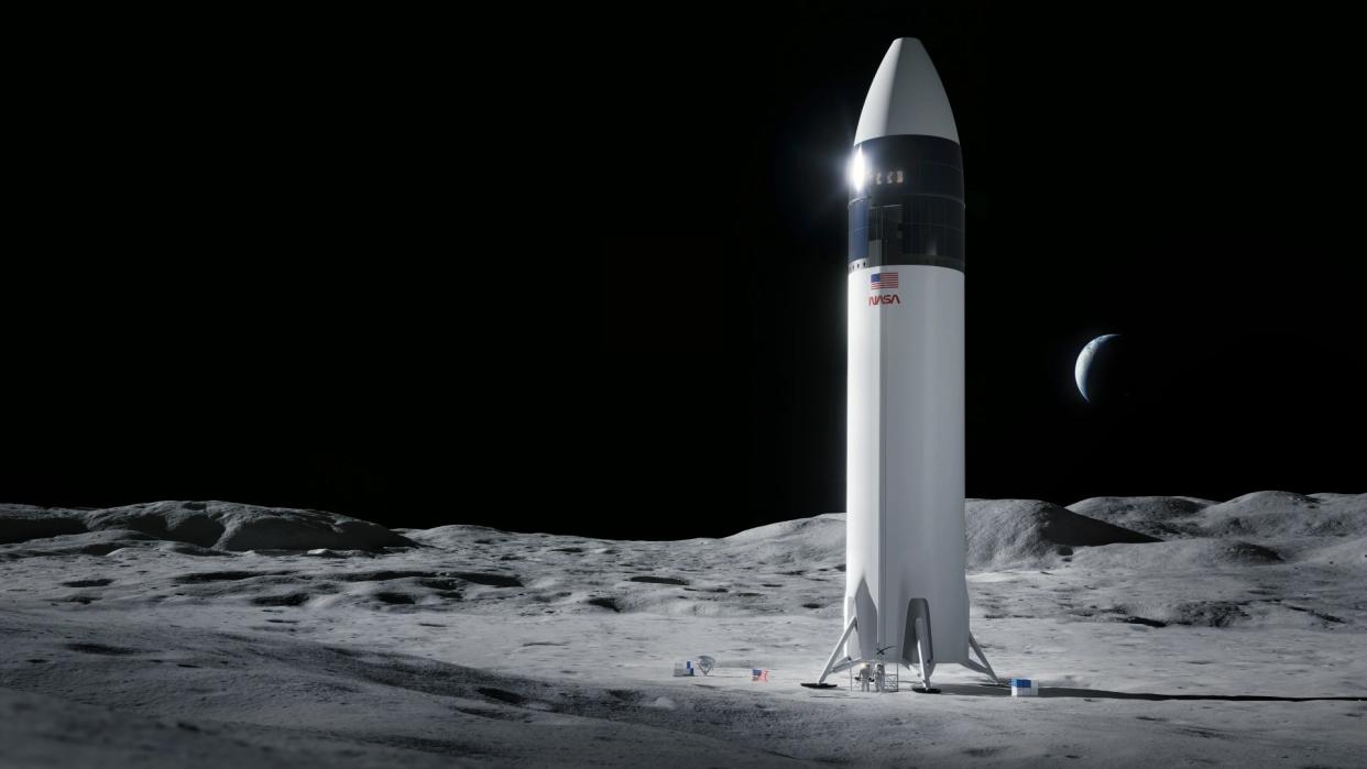  Astronauts stand beneath a giant white rocket on the surface of the moon. 