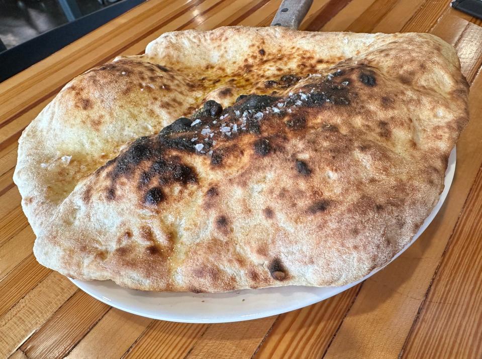 Hearth fired pita ready to rip and dip with several spreads from the kitchen at UnHitched.