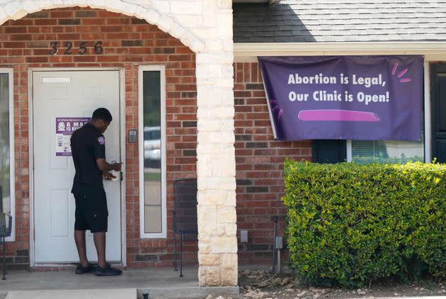 A security guard opens the door to the Whole Women's Health Clinic in Fort Worth, Texas, on Sept. 1, 2021. Texas has released data showing a marked drop in abortions at clinics in the state in the first month under the nation's strictest abortion law. (Photo: LM Otero via Associated Press)