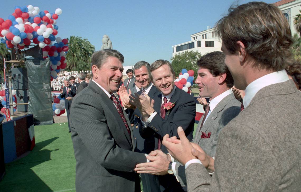 President Ronald Reagan shakes hands with baseball player Steve Garvey before a campaign rally at the San Diego County Administration Center in October 1984. California Gov. George Deukmejian, center, and Sen. Pete Wilson applaud.