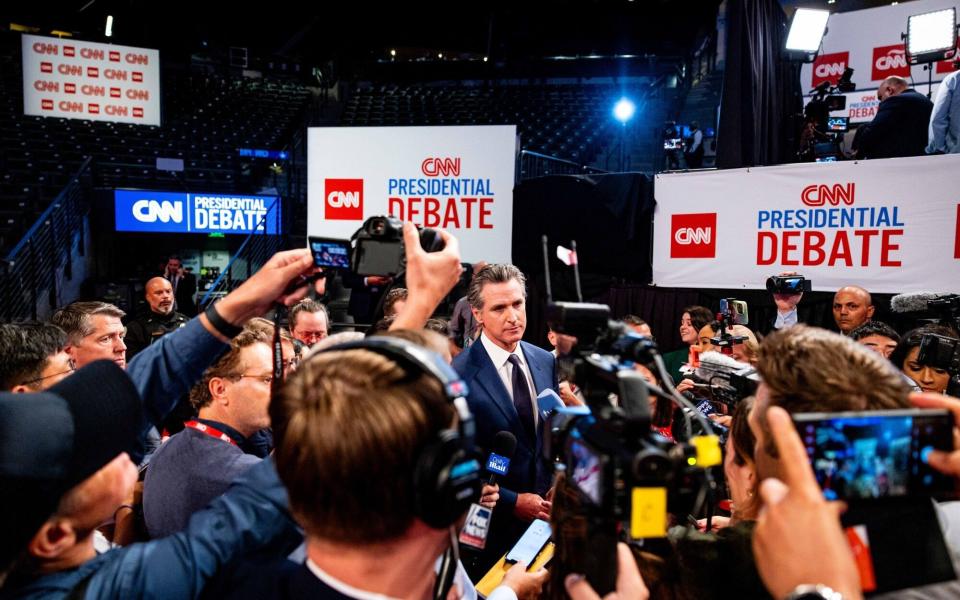 Gavin Newsom, governor of California, center, speaks to members of the media ahead of the debate between Donald Trump and Joe Biden