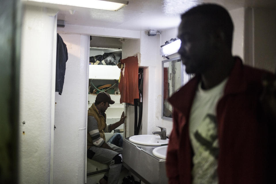 In this photo taken on Saturday, Nov. 24, 2018 photo, migrants rest on Nuestra Madre de Loreto, a Spanish fishing vessel that rescued twelve migrants two days ago about 78 miles north off Libyan shore. The Open Arms assisted migrants medically and provided them with food, blankets and clothes. (AP Photo/Javier Fergo)