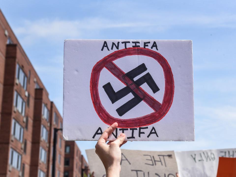 A counter protester holds a sign with the words "Antifa" (anti-fascists) outside of the Boston Commons and the Boston Free Speech Rally in Boston: REUTERS