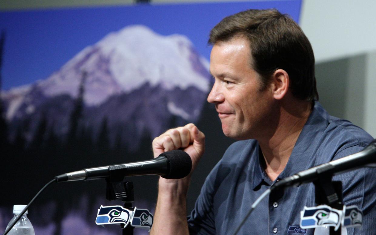 Former Seattle Seahawks coach Jim Mora pumps his fist as he talks about his expectation to complete a climb of Mount Rainier at the team's headquarters in Renton, Wash. on June 9, 2009.