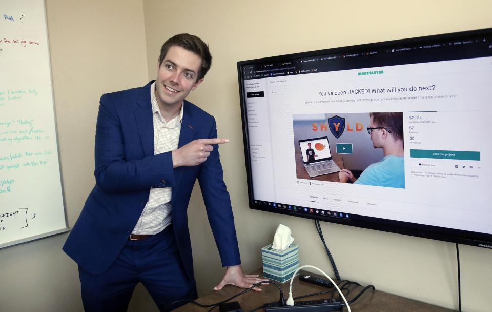 In this Aug. 27, 2019 photo, Tyler Olson poses in hits office at the University of St. Thomas - Minneapolis campus. Olson is just starting a cybersecurity company. (AP Photo/Jim Mone)