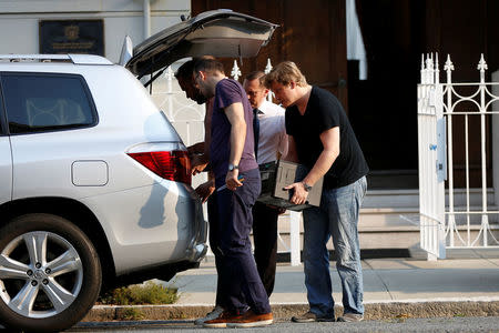 Members of the Consulate General of Russia carry equipment into a van in San Francisco, California, U.S. September 2, 2017. REUTERS/Stephen Lam