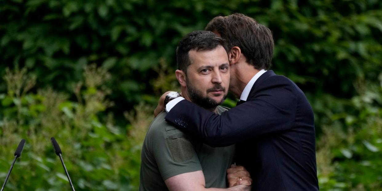 French President Emmanuel Macron embracing Ukrainian President Volodymyr Zelenskyy