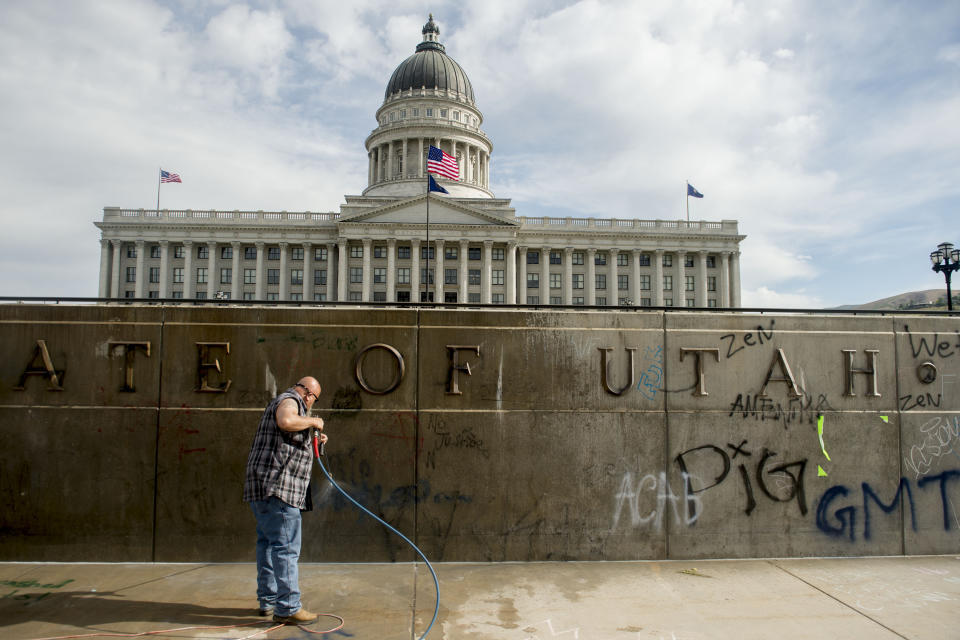 Don Gamble cleans up graffiti at the Capitol in Salt Lake City on Sunday, May 31, 2020, following protests over the death of George Floyd. Protests were held throughout the country over the death of Floyd, a black man who died after being restrained by Minneapolis police officers on May 25. (Jeremy Harmon/The Salt Lake Tribune via AP)