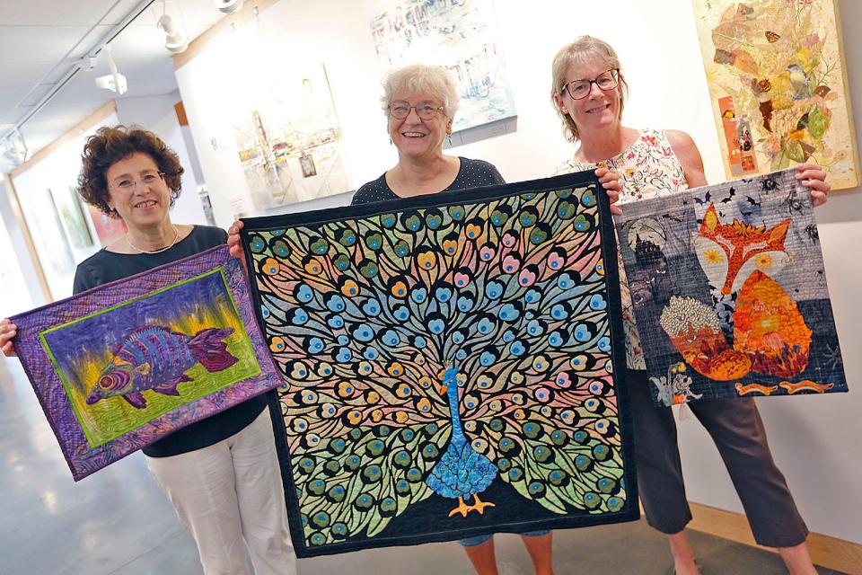 From left, Rosemarie Gentile, Nancy Robertson and Holly Carpenter with quilts made by members of the Herring Run Quilters' Guild in Scituate, which is preparing for its large show in Marshfield on Sept. 24-25.