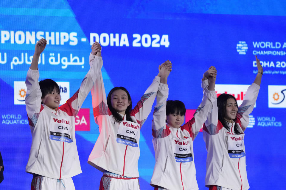 Gold medalists Ai Yanhan, Gong Zhenqi, Li Bingjie and Yang Peiqi of China celebrate during the medal ceremony for the women's 4x200m freestyle final at the World Aquatics Championships in Doha, Qatar, Thursday, Feb. 15, 2024. (AP Photo/Lee Jin-man)