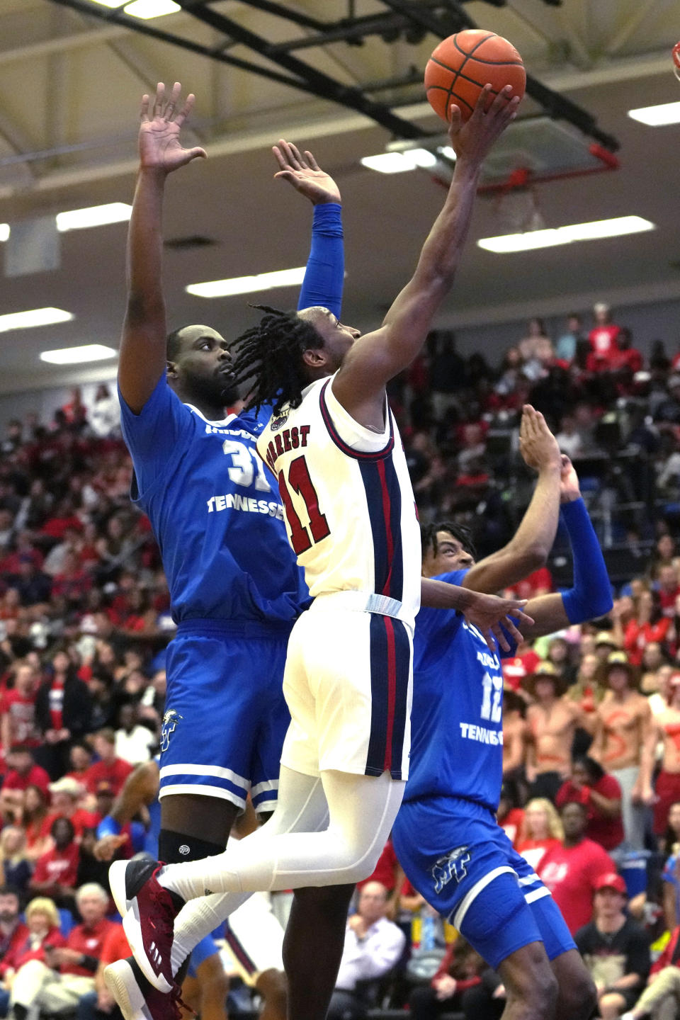 Florida Atlantic guard Michael Forrest (11) goes to the basket as Middle Tennessee forward Jared Coleman-Jones (31) defends during the first half of an NCAA college basketball game Thursday, Jan. 26, 2023, in Boca Raton, Fla. (AP Photo/Lynne Sladky)