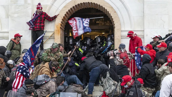 Rioters clash with police trying to enter Capitol building through the front doors. Rioters broke windows and breached the Capitol building in an attempt to overthrow the results of the 2020 election. (Lev Radin/Pacific Press/LightRocket via Getty Images)