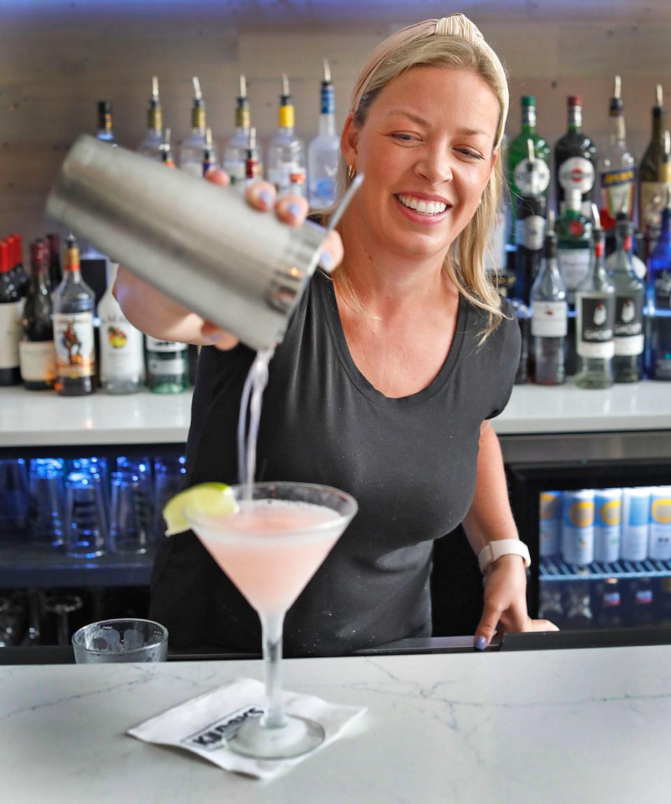 Bartender Caitlin Mahoney pours a freshly shaken Cosmopolitan with Kettle One vodka, Cointreau, cranberry and lime at Kilroy's on the Square in downtown Quincy.
