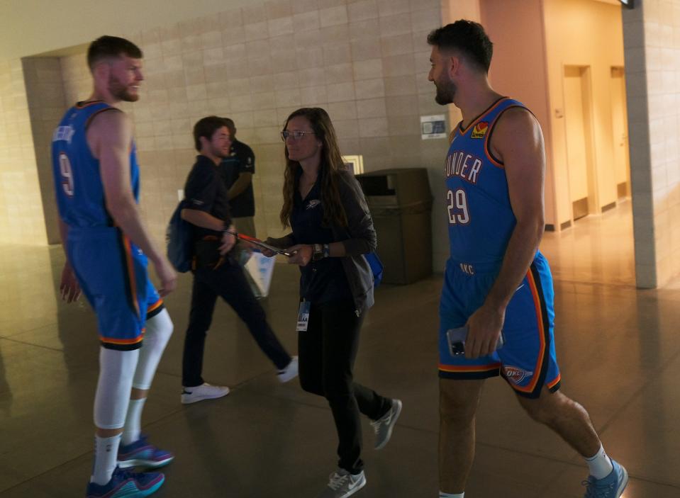 Davis Bertans (9) left, and Vasilije Micic (29) speak as they pass each other at Thunder Media Day, held in the Oklahoma City Convention Center on Monday, Oct. 2, 2023.