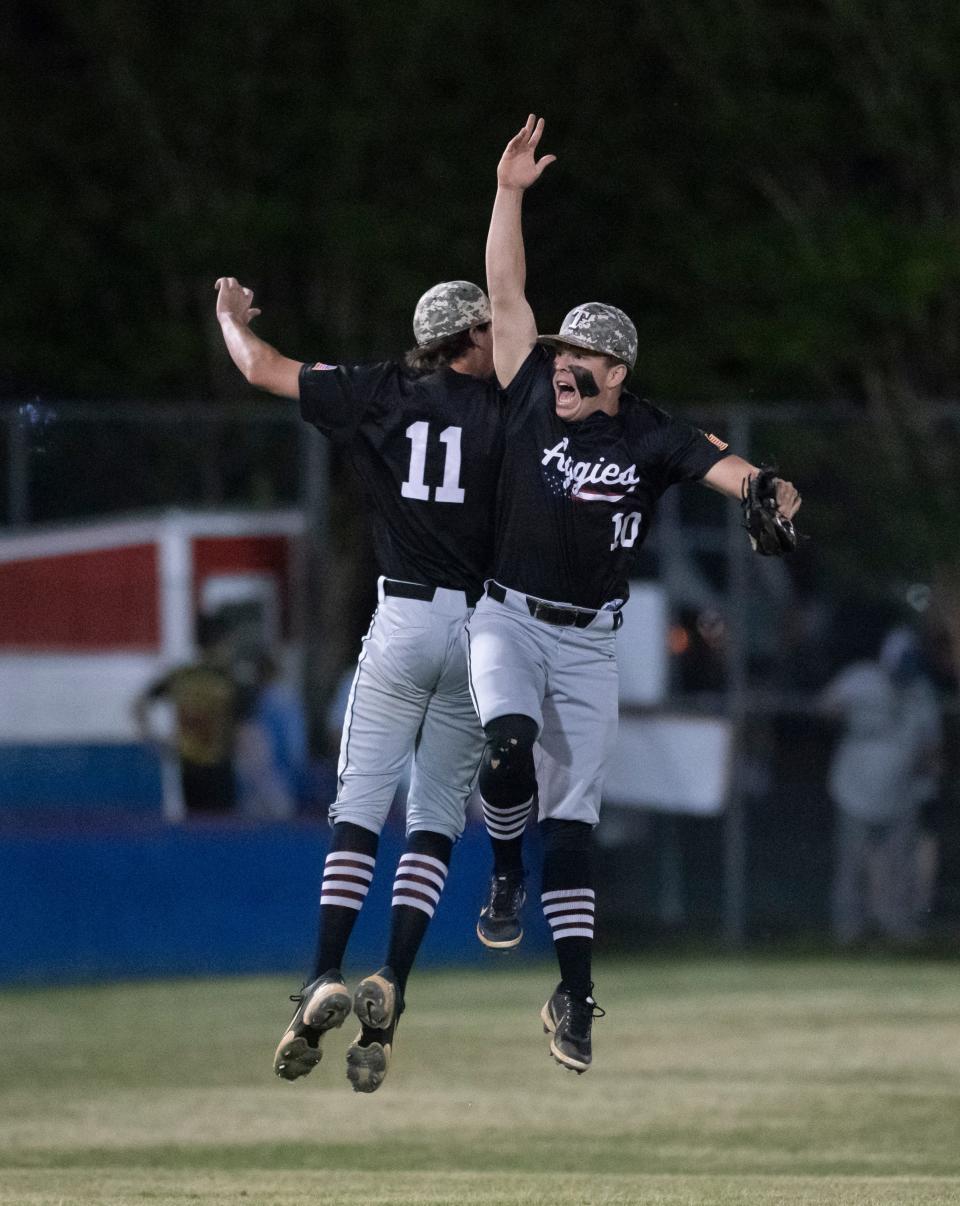 Rilee Lowery (11) and Jackson Penton (10)  celebrate the 2-0 Aggies victory in the Tate vs Pace baseball game at Pace High School on Friday, April 15, 2022.