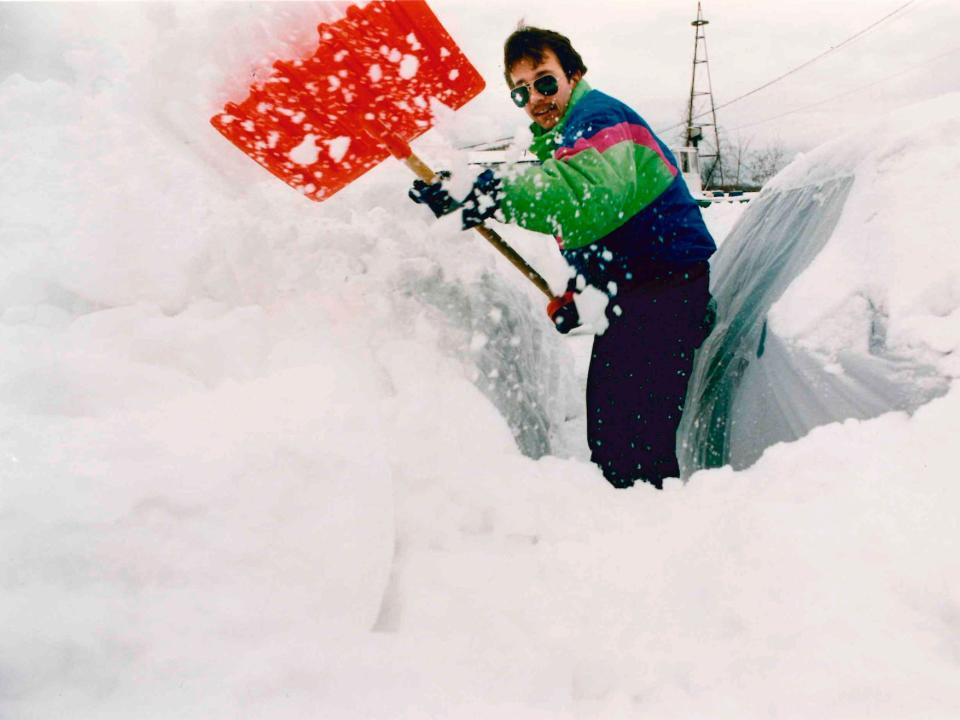 Dan Littlefield of Campe Ellis attempts to clear snow from his car Sunday morning, March 14, 1993. 