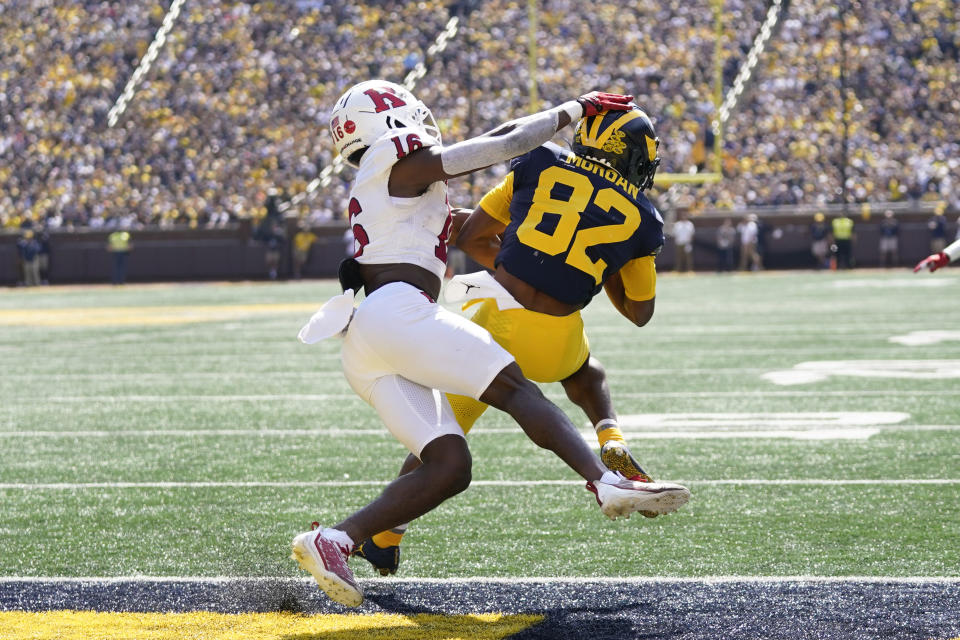 Michigan wide receiver Semaj Morgan (82) catches a touchdown pass as Rutgers defensive back Max Melton (16) defends in the first half of an NCAA college football game in Ann Arbor, Mich., Saturday, Sept. 23, 2023. (AP Photo/Paul Sancya)
