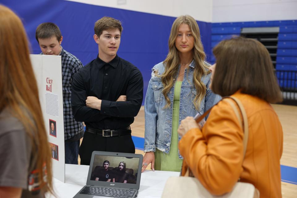 Ravenna High School seniors Drayden Winning (left) and Morgan Skala give their presentation to guests of the Honors Ravenna Civics class symposium held at the high school.