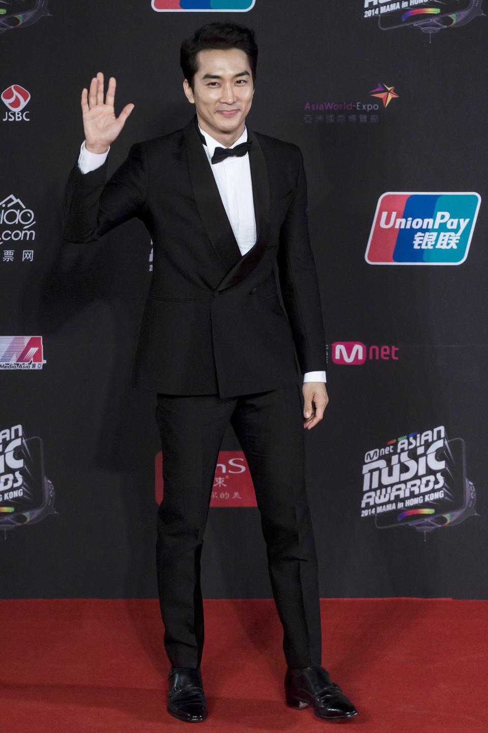 South Korean actor Song Seung-heon, poses on the red carpet as he attends the 2014 Mnet Asian Music Awards (MAMA) in Hong Kong