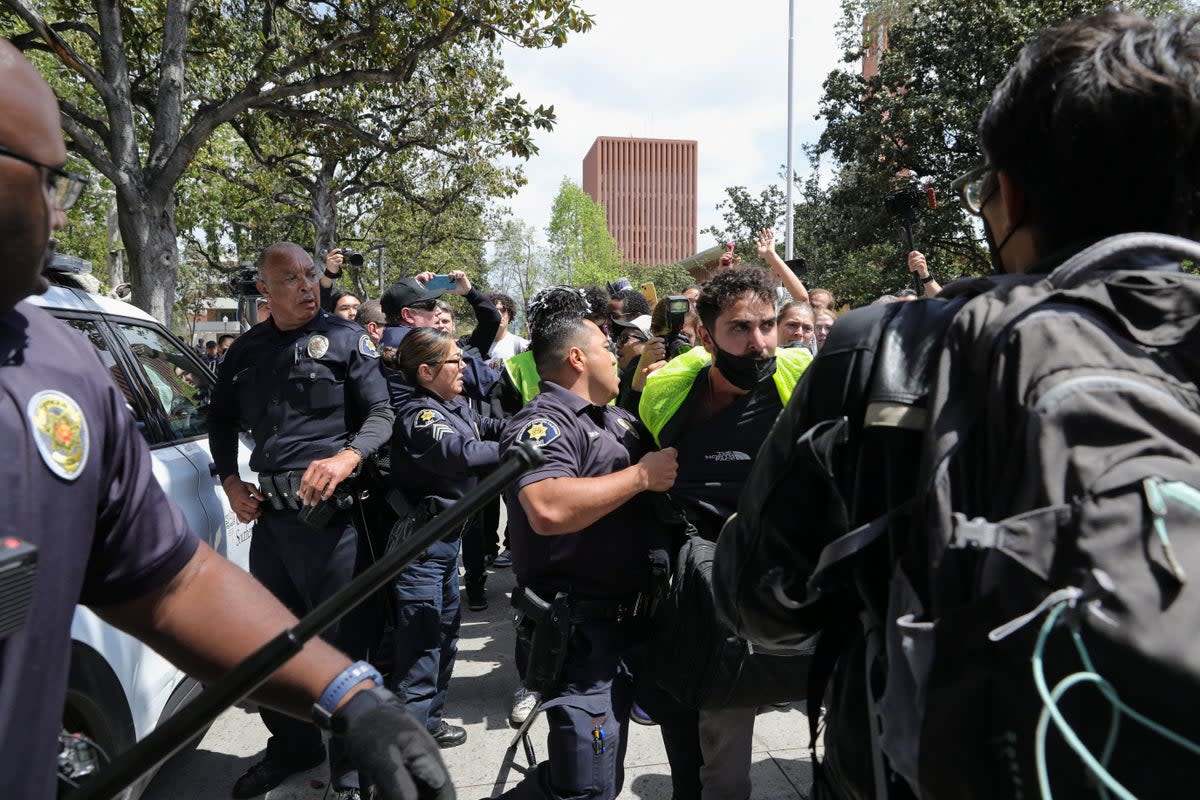 USC Safety officers try to disperse students who protest in support of Palestinians, at the University of Southern California's Alumni Park, during demonstraions on 24 April (REUTERS)