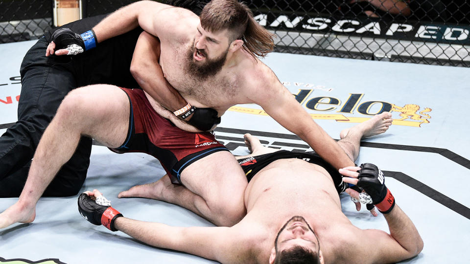 Tanner Boser is retrained after knocking out Philipe Lins. (Getty Images)