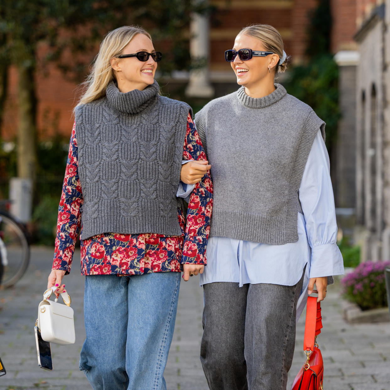  two women wearing gray sweater vests 