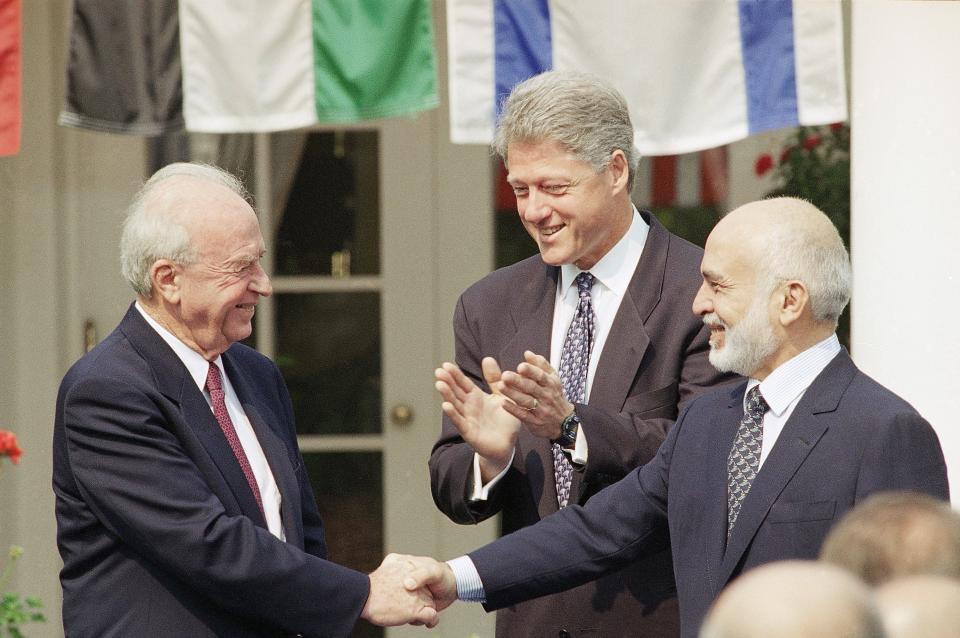 In this file photo, President Clinton, center, looks on as Israeli Prime Minister Yitzhak Rabin, left, shakes hands with King Hussein of Jordan at the White House on July 25, 1994, prior to the start of peace talks. The two leaders were ready to sign a declaration that was aimed at ending years of belligerency between the two countries as well as provide a blueprint for economic cooperation.