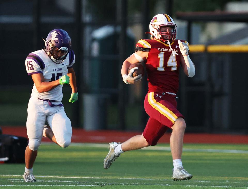 Cardinal Spellman's Jay Comeau scores a touchdown on special teams running past Martha's Vineyard defender Rebel Dos Santos during game on Thursday, Sept. 14, 2023.