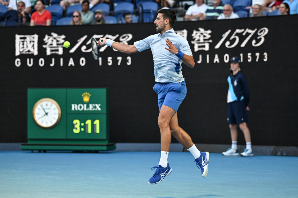 Serbia's Novak Djokovic hits a return against USA's Taylor Fritz during their men's singles quarter-final match on day 10 of the Australian Open tennis tournament in Melbourne on January 23, 2024. (Photo by Paul Crock / AFP) / -- IMAGE RESTRICTED TO EDITORIAL USE - STRICTLY NO COMMERCIAL USE -- (Photo by PAUL CROCK/AFP via Getty Images)