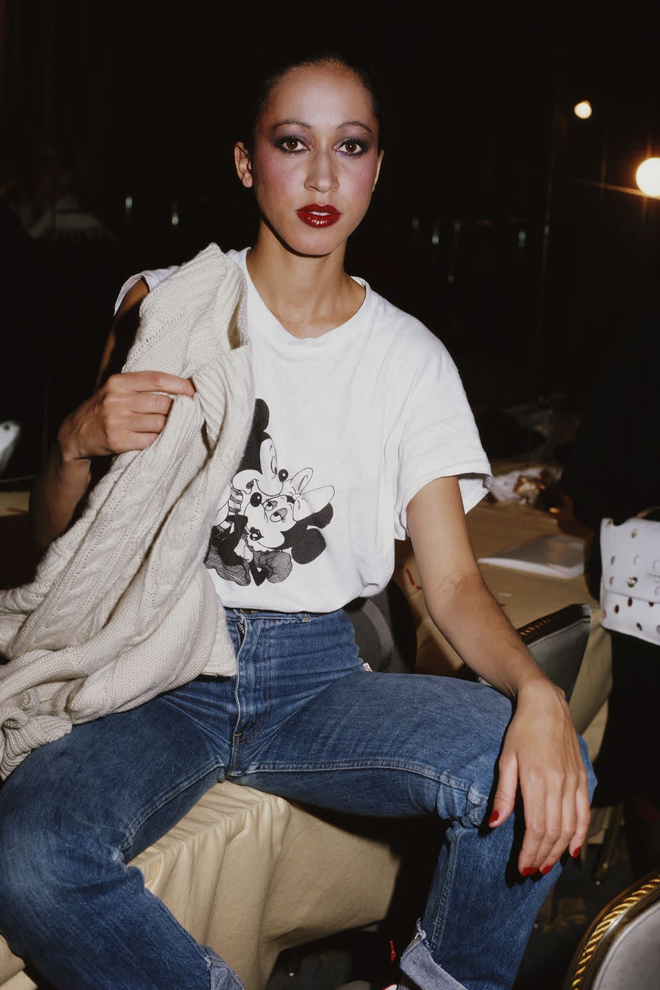 <p>Pat Cleveland in a Mickey Mouse T-shirt and high-waisted jeans. </p>