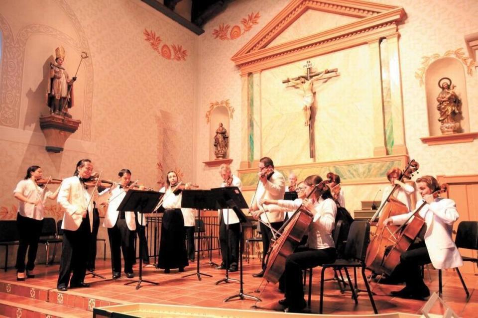 Festival Mozaic music director Scott Yoo, front row, far left, leads the orchestra in concert at Mission San Luis Obispo de Tolosa in July 2013.