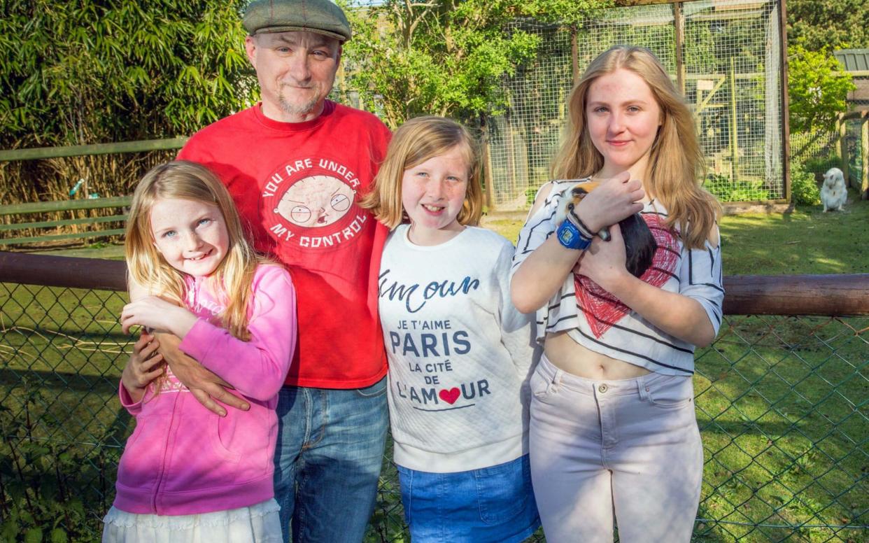 Dean Tweedy with his daughters (L-R) Paige, Sarah and Sophie at Borth Wild Animal Kingdom - Caters News Agency