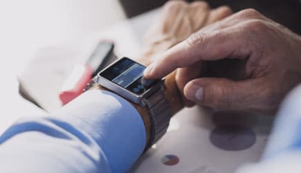 Businessman using smartwatch.