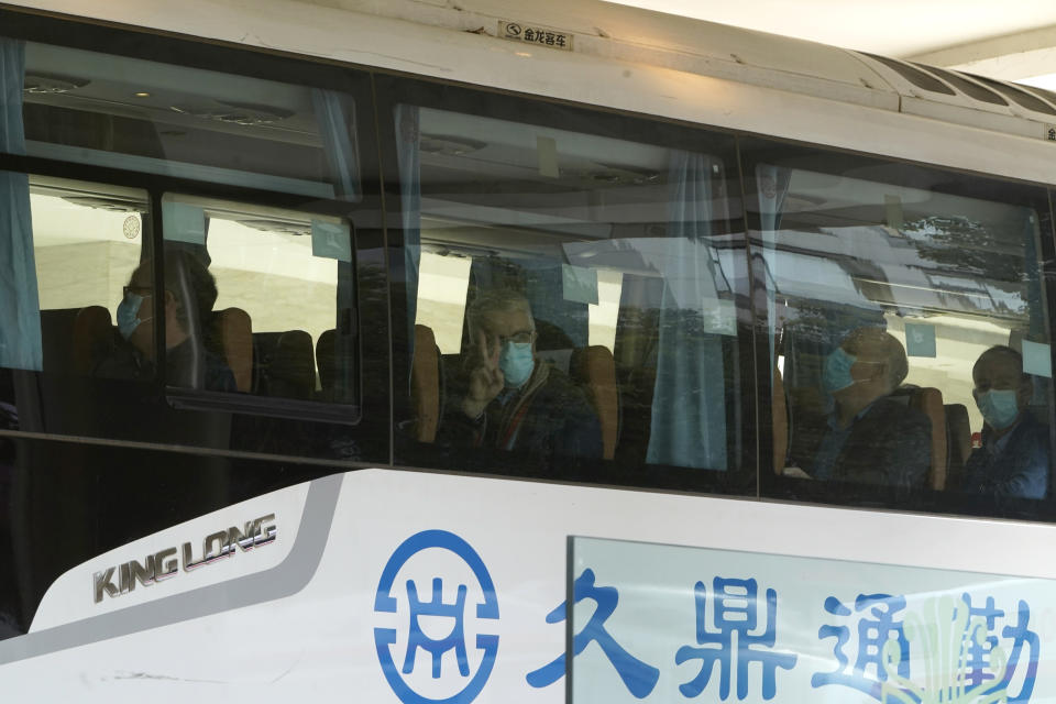 Members from the World Health Organization team of experts prepare to leave on a bus after ending their quarantine at a hotel in Wuhan in central China's Hubei province on Thursday, Jan. 28, 2021. (AP Photo/Ng Han Guan)