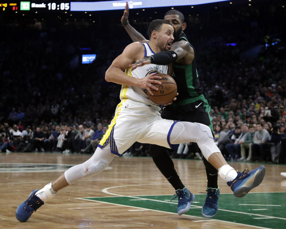 Golden State Warriors guard Stephen Curry drives against Boston Celtics guard Kyrie Irving in the second half of an NBA basketball game Saturday, Jan. 26, 2019, in Boston. The Warriors won 115-111. (AP Photo/Elise Amendola)