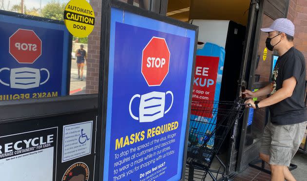 People shop at a grocery store enforcing the wearing of masks in Los Angeles on July 23. (Photo: CHRIS DELMAS via Getty Images)