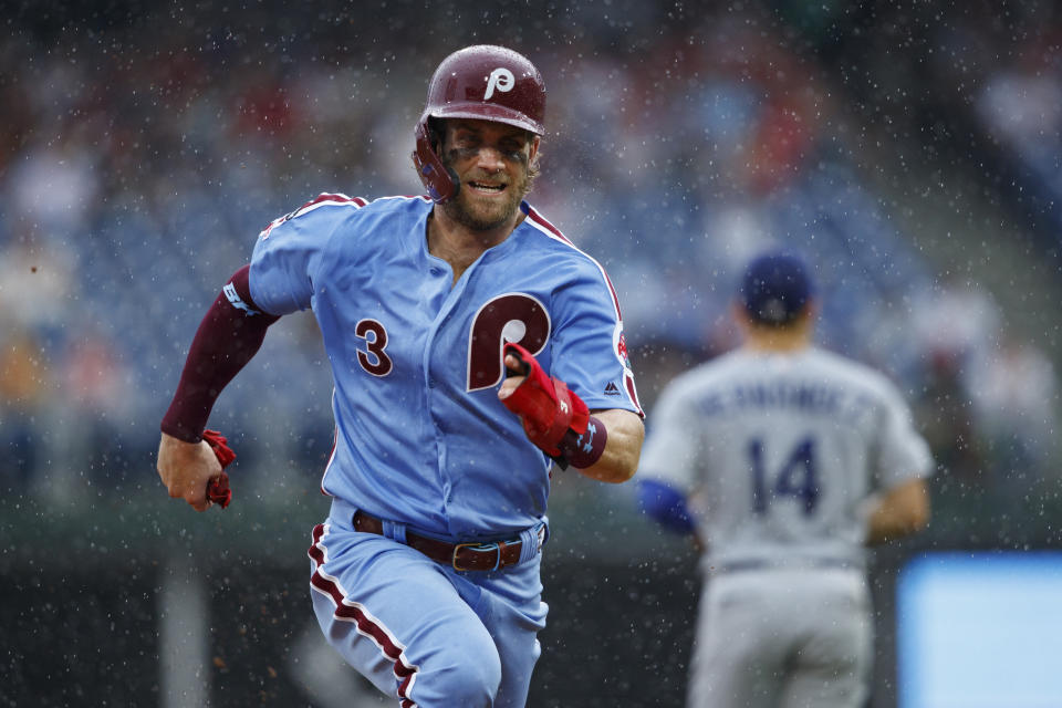 Philadelphia Phillies' Bryce Harper runs to third base on a fielding error by Los Angeles Dodgers second baseman Max Muncy on a pop-up by Rhys Hoskins during the third inning of a baseball game, Thursday, July 18, 2019, in Philadelphia. Hoskins was safe at first on the play. (AP Photo/Matt Slocum)