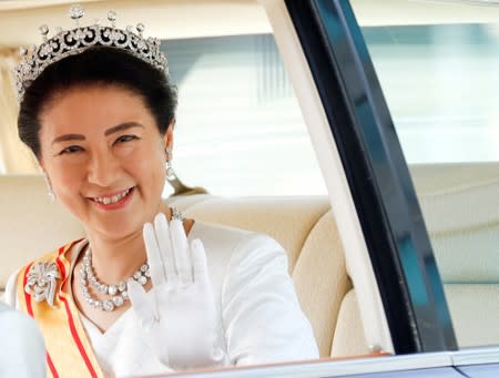 FILE PHOTO: Japan’s new Empress Masako waves from her vehicle upon arriving at the Imperial Palace in Tokyo, Japan