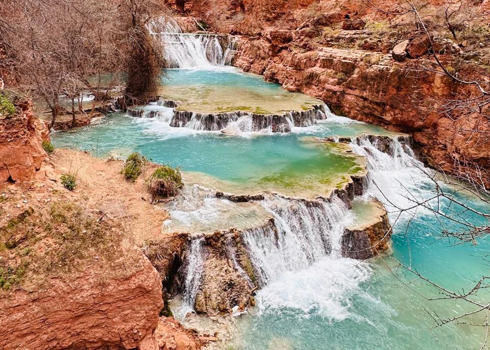 Beaver Falls in Havasupai: A series of smaller waterfalls with blue-green water surrounded by red rock.