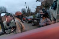 Larrecsa Cox, right, who leads the Quick Response Team whose mission is to save every citizen who survives an overdose from the next one, talks with paramedics at an overdose call in Huntington, W.Va., Wednesday, March 17, 2021. The formation of the team helped bring down the county's overdose rate. Then the pandemic arrived, and Cox watched it undo much of their effort: overdoses shot up again, so did HIV diagnoses. "I can't believe we've lost all these people. But sometimes, you just have to focus on the living," she said. (AP Photo/David Goldman)