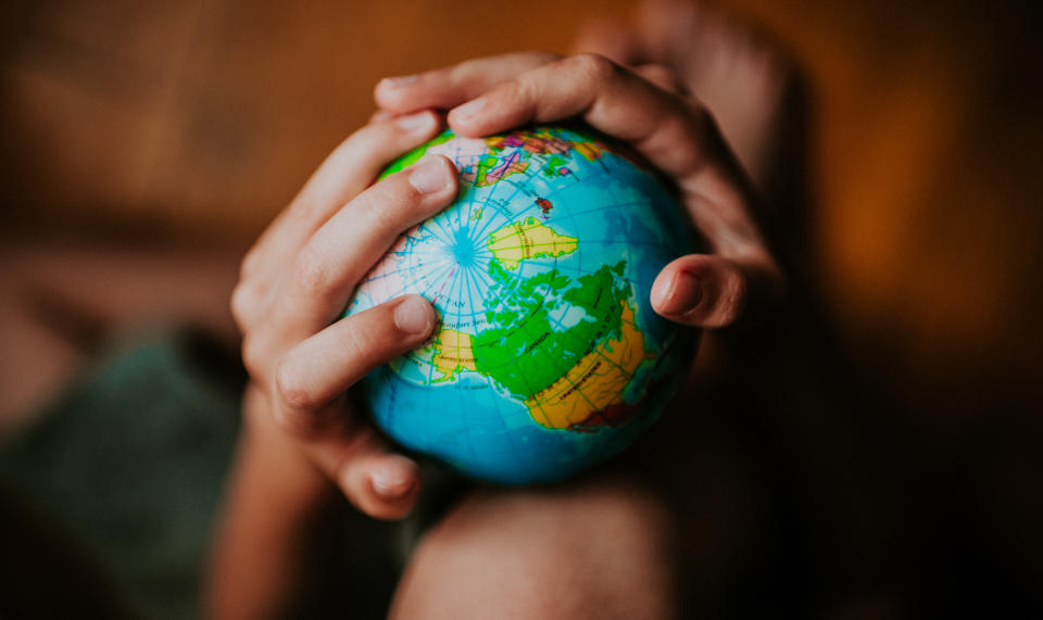 Pictured: Model of the planet held by child. Images: Getty