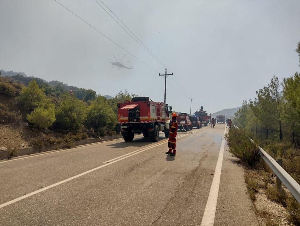 Firefighters try to extinguish a wildfire burning near Laerma, Rhodes Island (via REUTERS)