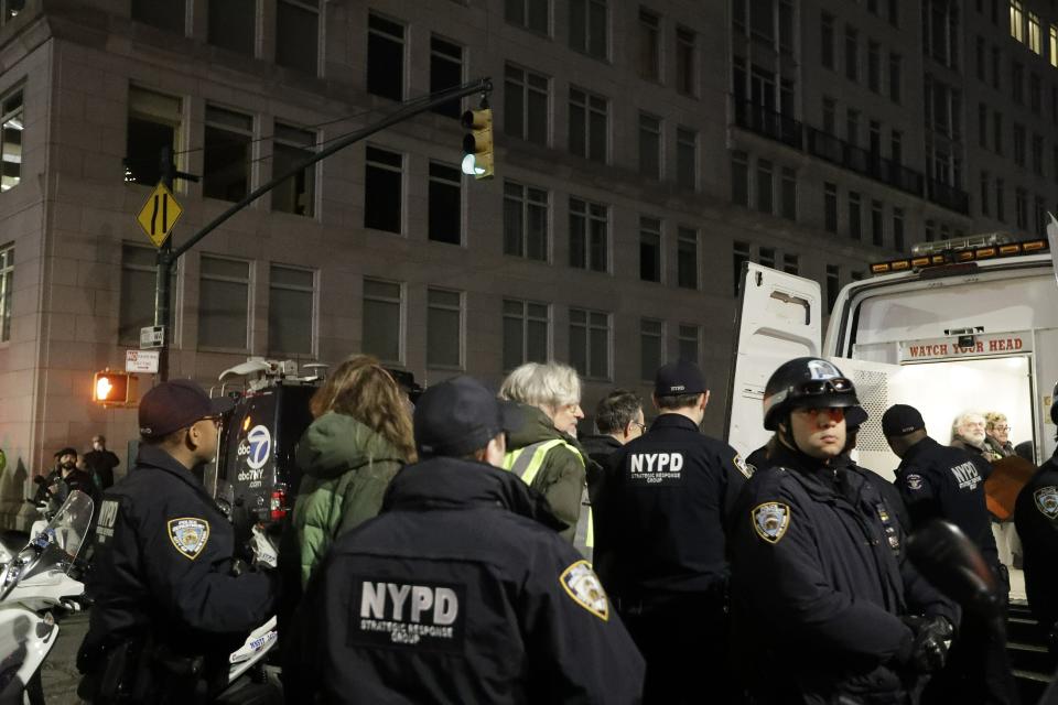 Protesters are taken into custody near Trump International Hotel & Tower on Friday, Feb. 15, 2019, in New York. Some people have been arrested while protesting President Donald Trump's national emergency declaration outside a New York City hotel that bears his name. The NYPD wasn't immediately able to say how many people were taken into custody Friday night. (AP Photo/Frank Franklin II)