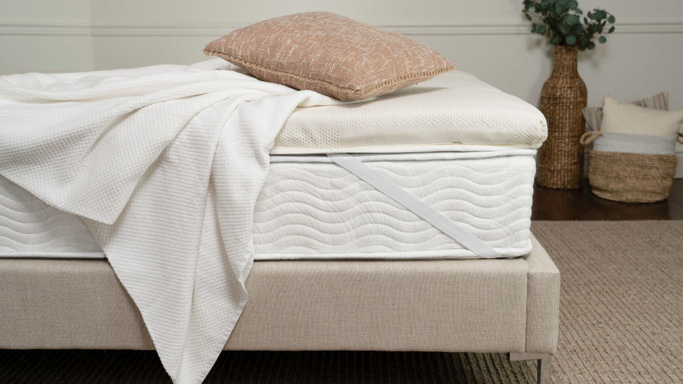 The Saatva Micro-Coil mattress topper on a bed