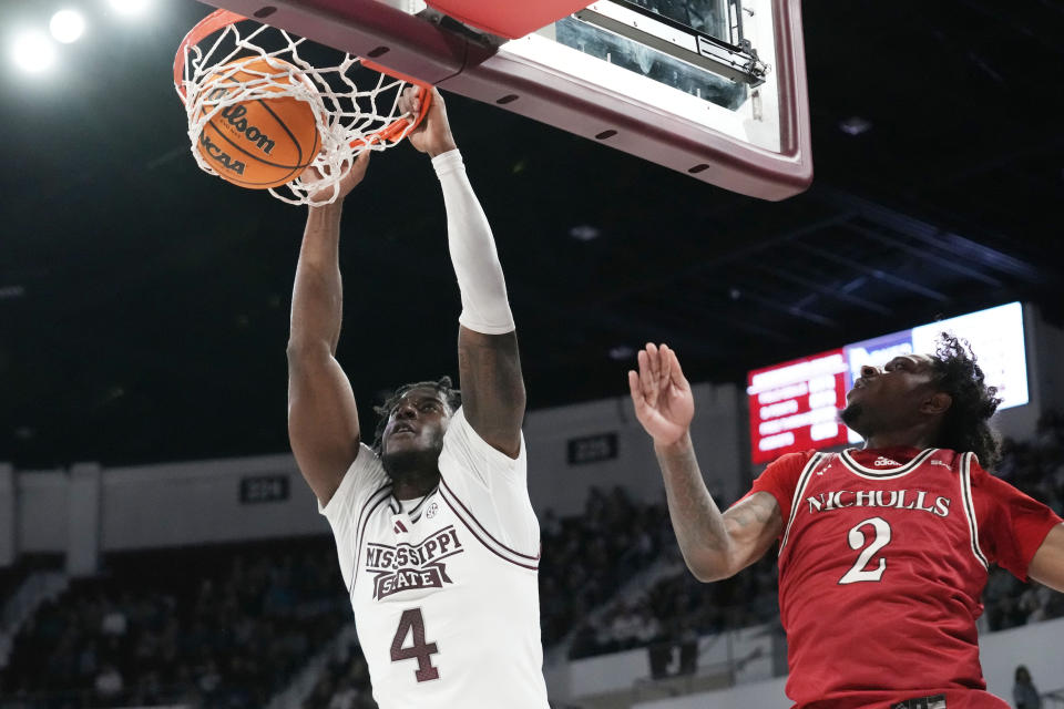 Mississippi State forward Cameron Matthews (4) dunks past Nicholls State guard Robert Brown III (2) during the first half of an NCAA college basketball game in Starkville, Miss., Friday, Nov. 24, 2023. (AP Photo/Rogelio V. Solis)