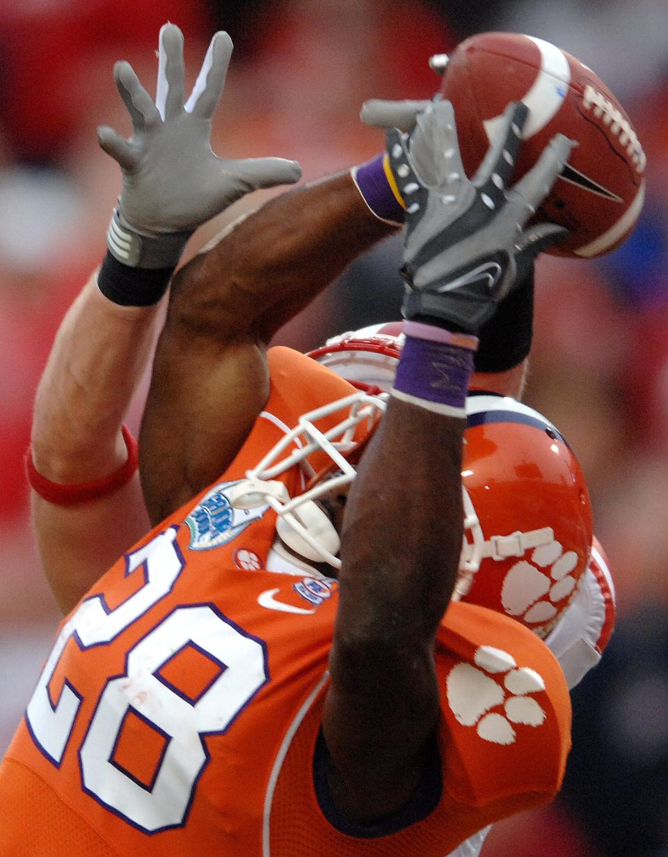 Clemson running back C.J. Spiller (28) of Union County has the ball knocked out of his hands by Nebraska safety Matt Hanlon with 1:37 left in the 2009 Gator Bowl. Nebraska won 26-21.