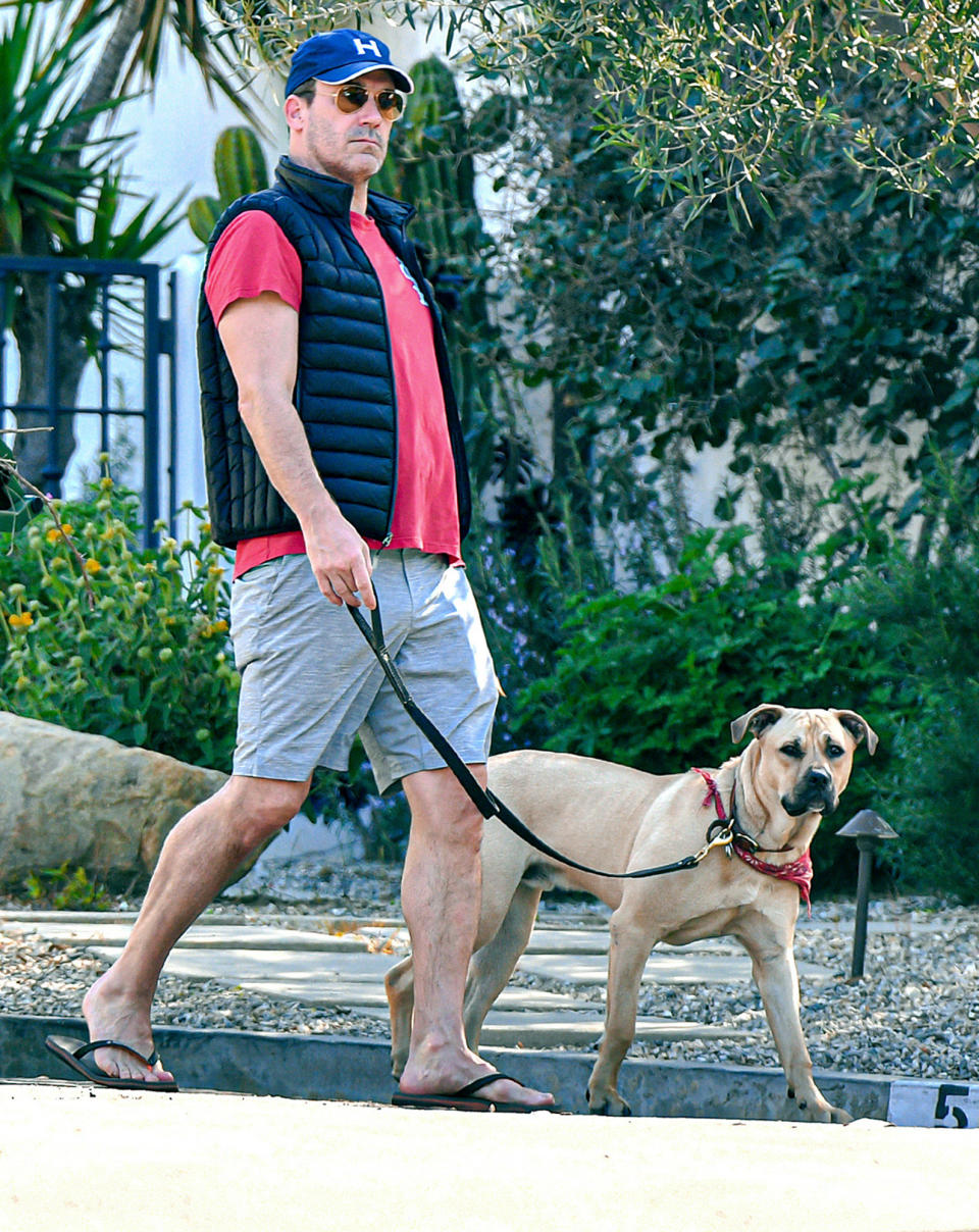 <p>Jon Hamm wears a vest, shorts and flip flops while out walking his dog in L.A. on Wednesday.</p>