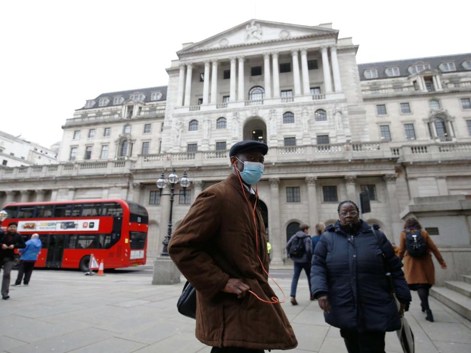 A man, wearing a protective face mask, walks in front of the Bank of England, following an outbreak of the coronavirus, in London: REUTERS